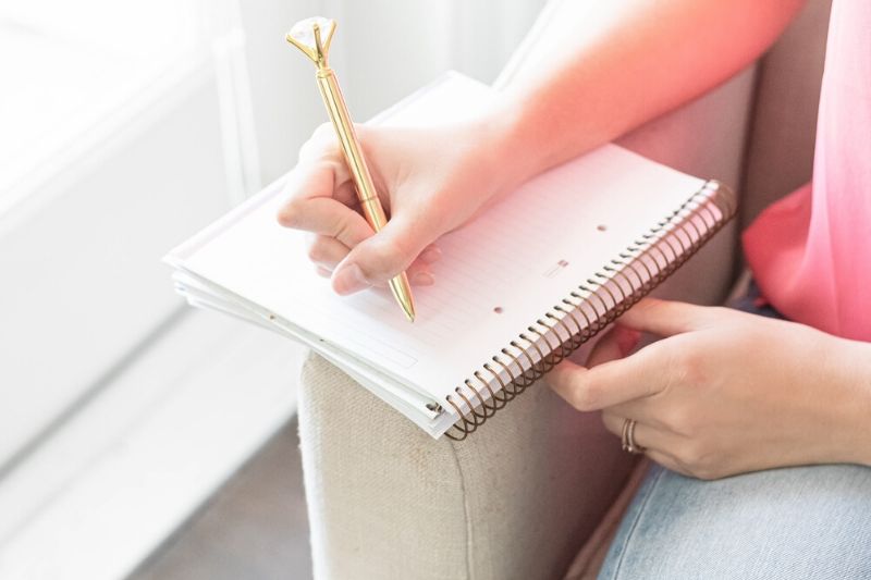 woman writing in a planner