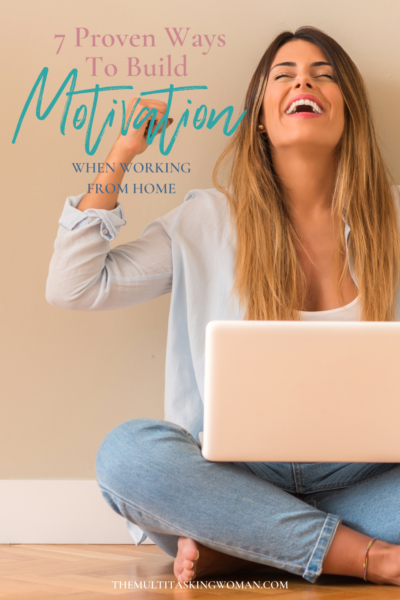 Woman rejoicing while sitting on the floor with her laptop